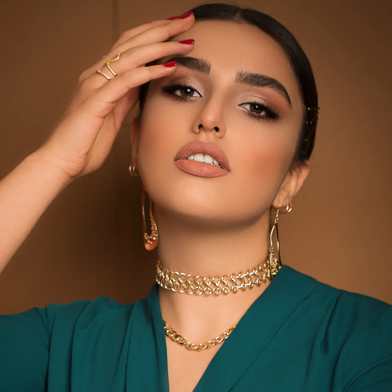 An elegant woman showcasing a designer necklace